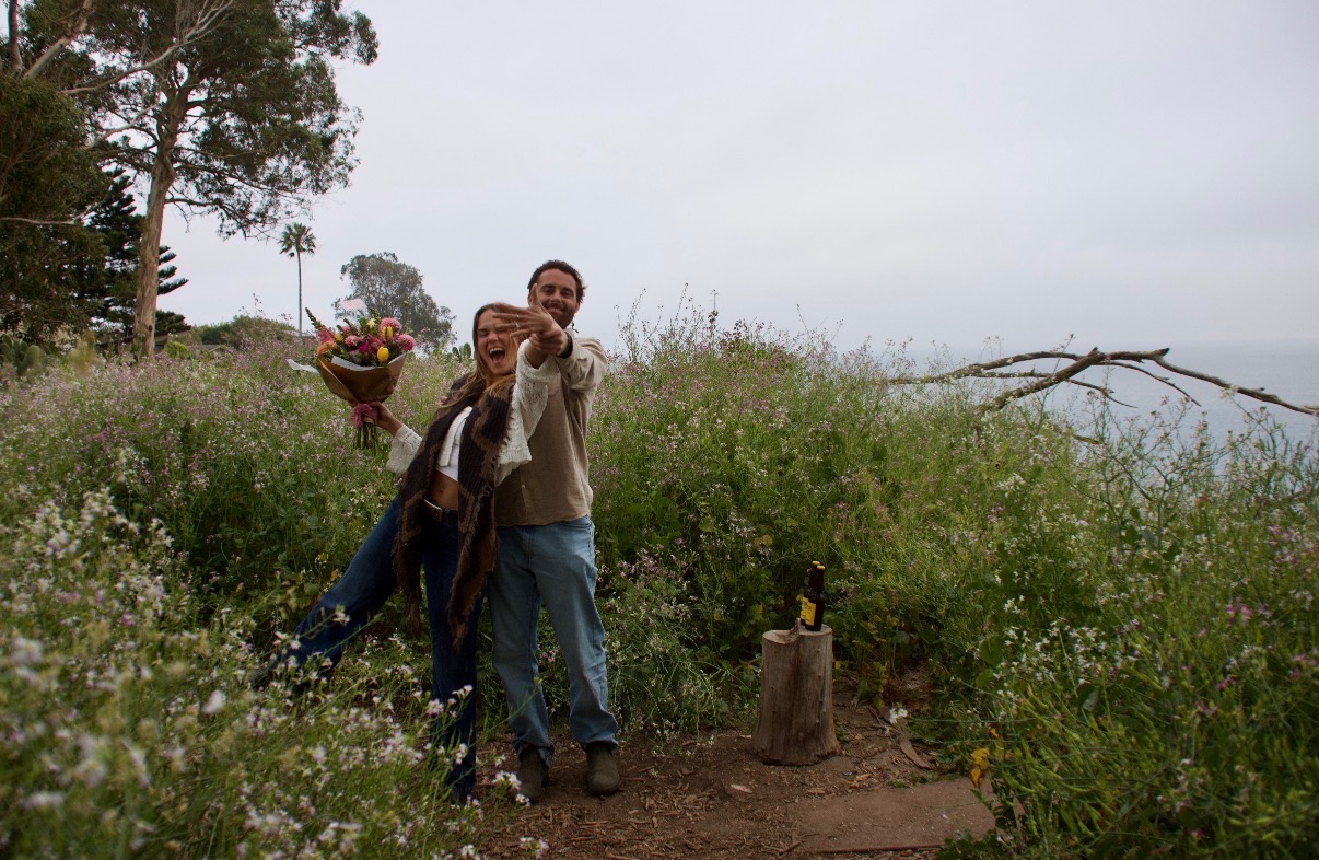 Claire and Willy on a coastal bluff with flowers