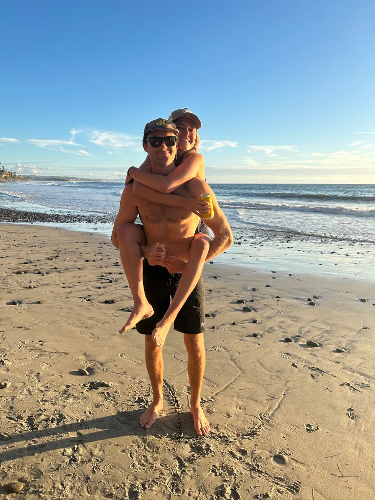 Willy giving Claire a piggyback ride on the beach