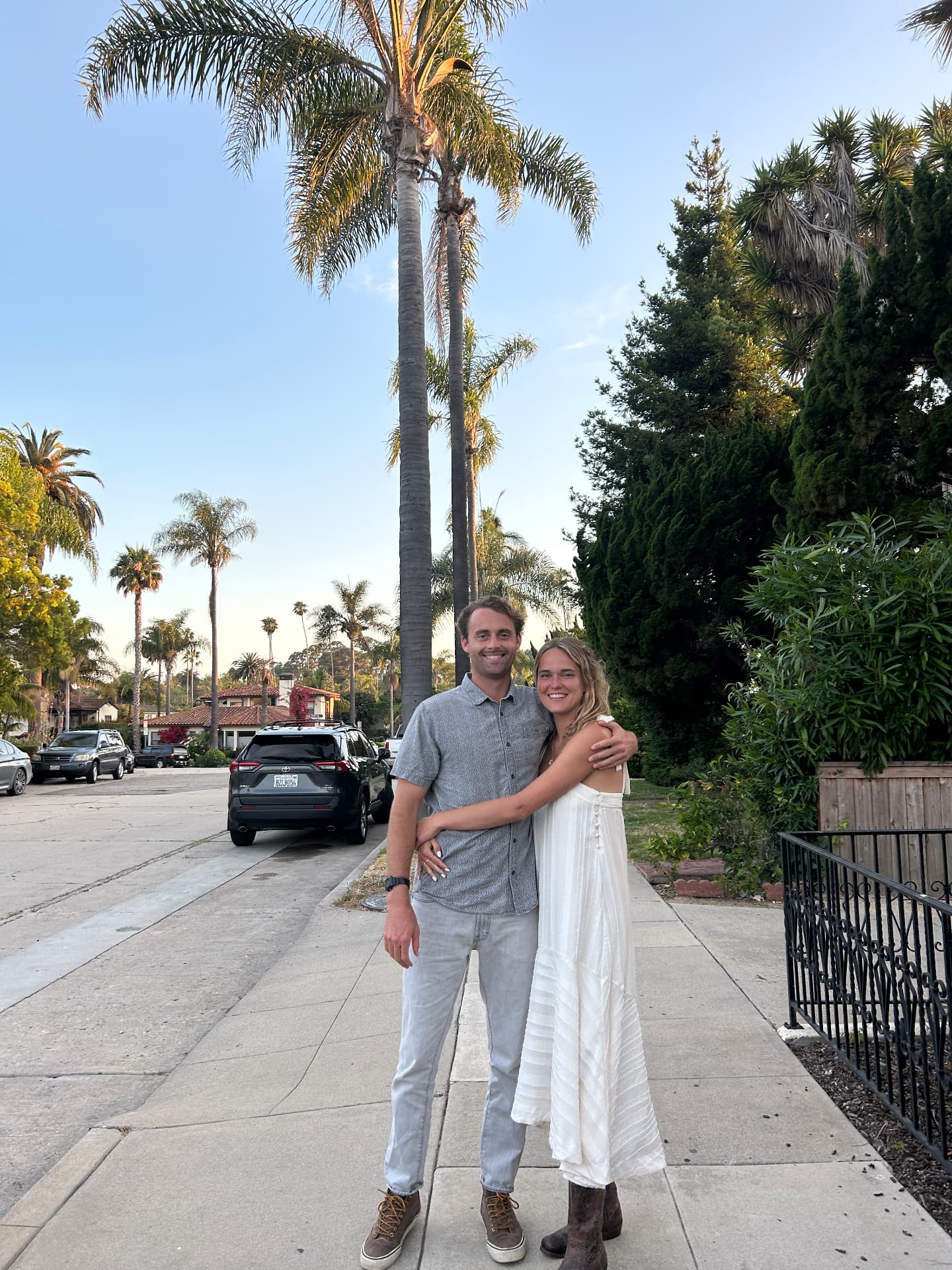 Claire and Willy on a palm-lined street